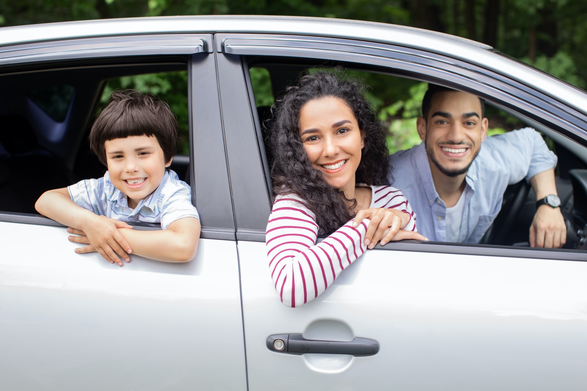 Happy Family Ride. Cheerful Arab Parents And Little Son Sitting In Car